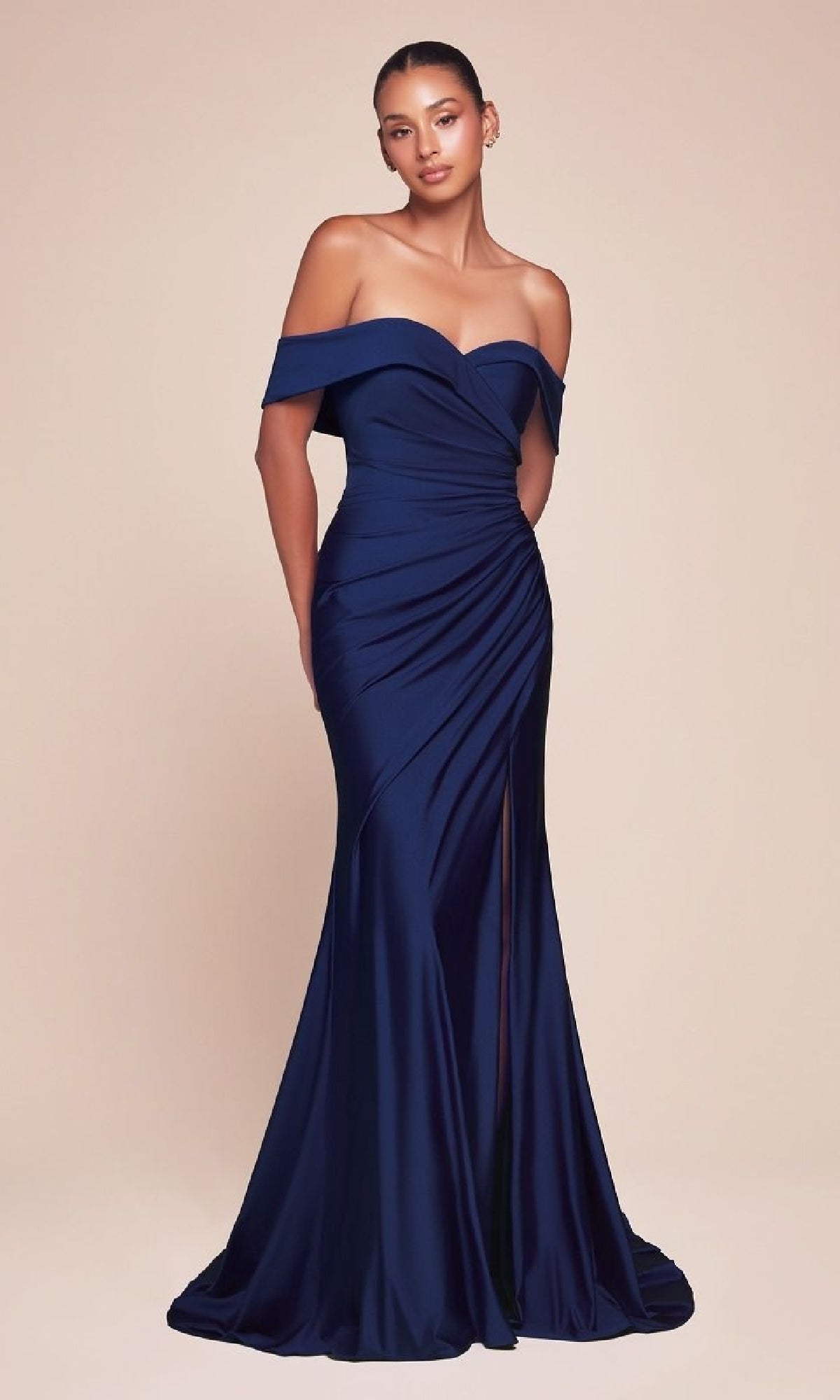 A woman wears the Off-the-Shoulder Long Prom Dress: Ladivine CD790, a dark blue satin gown with a sweetheart neckline and thigh-high slit, standing against a plain beige background.